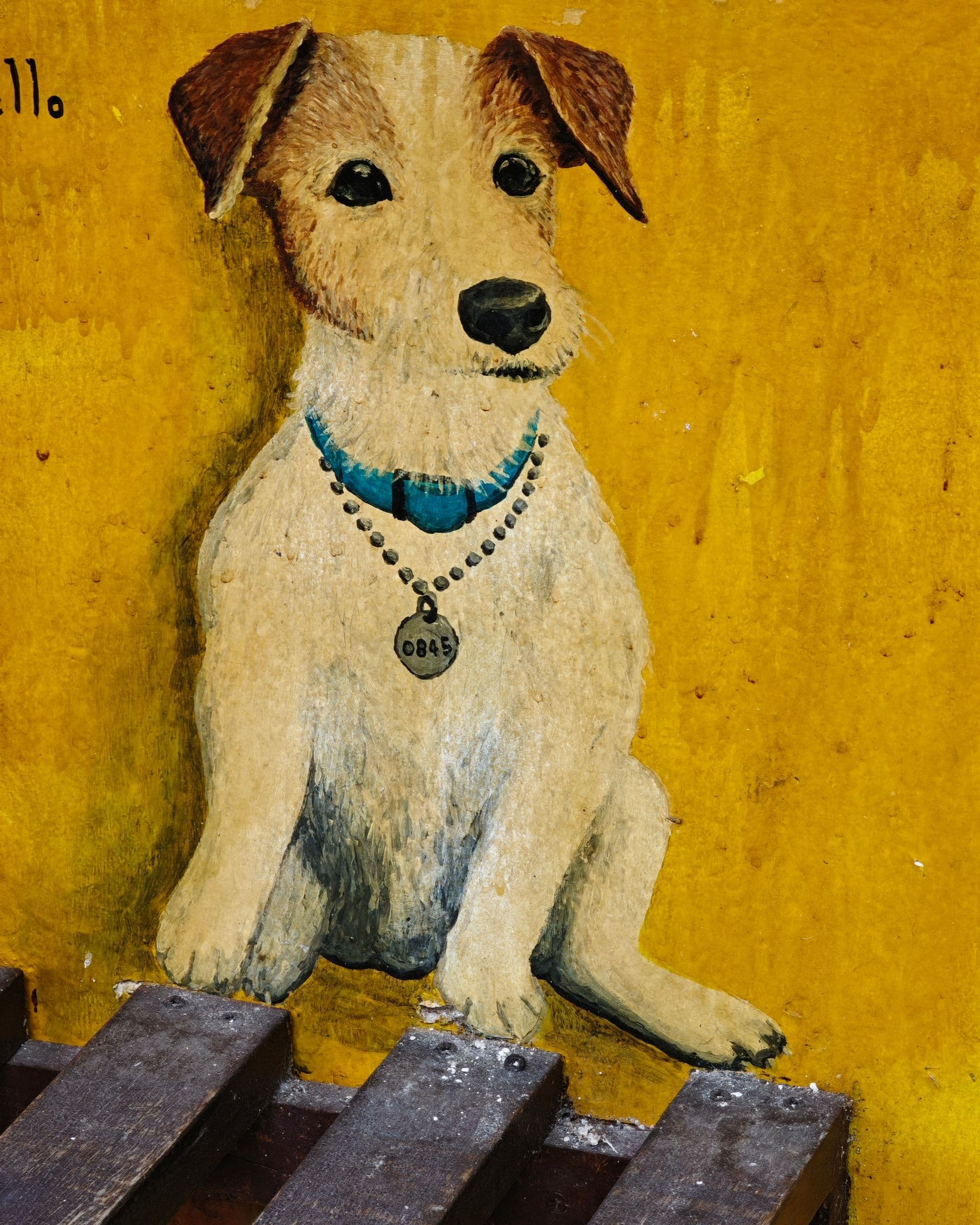 Small mural of a fox terrier or Jack Russell dog painted on a wall in George Town, Penang