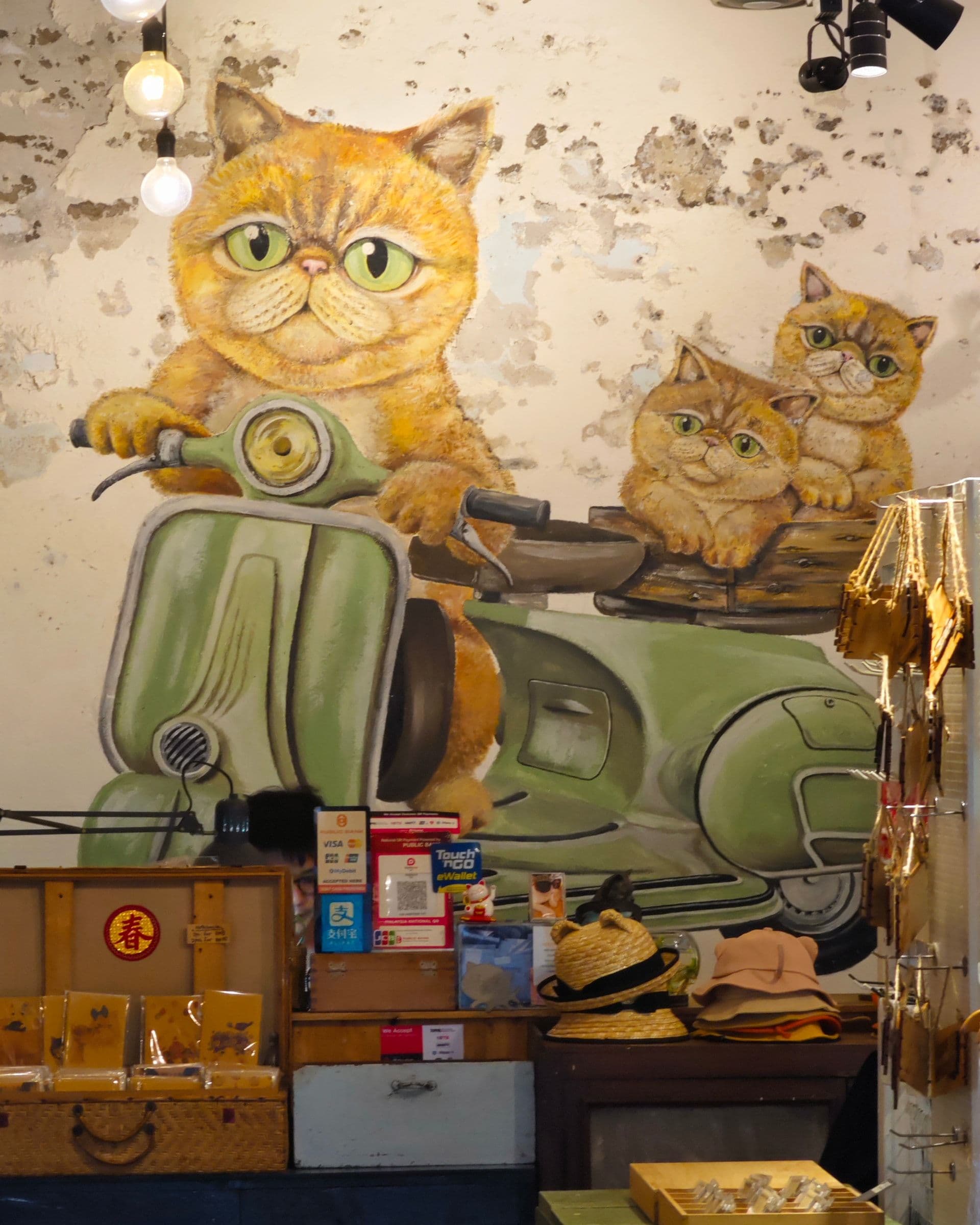 Cat-themed mural inside The Heritage Cat shop on Lebuh Acheh