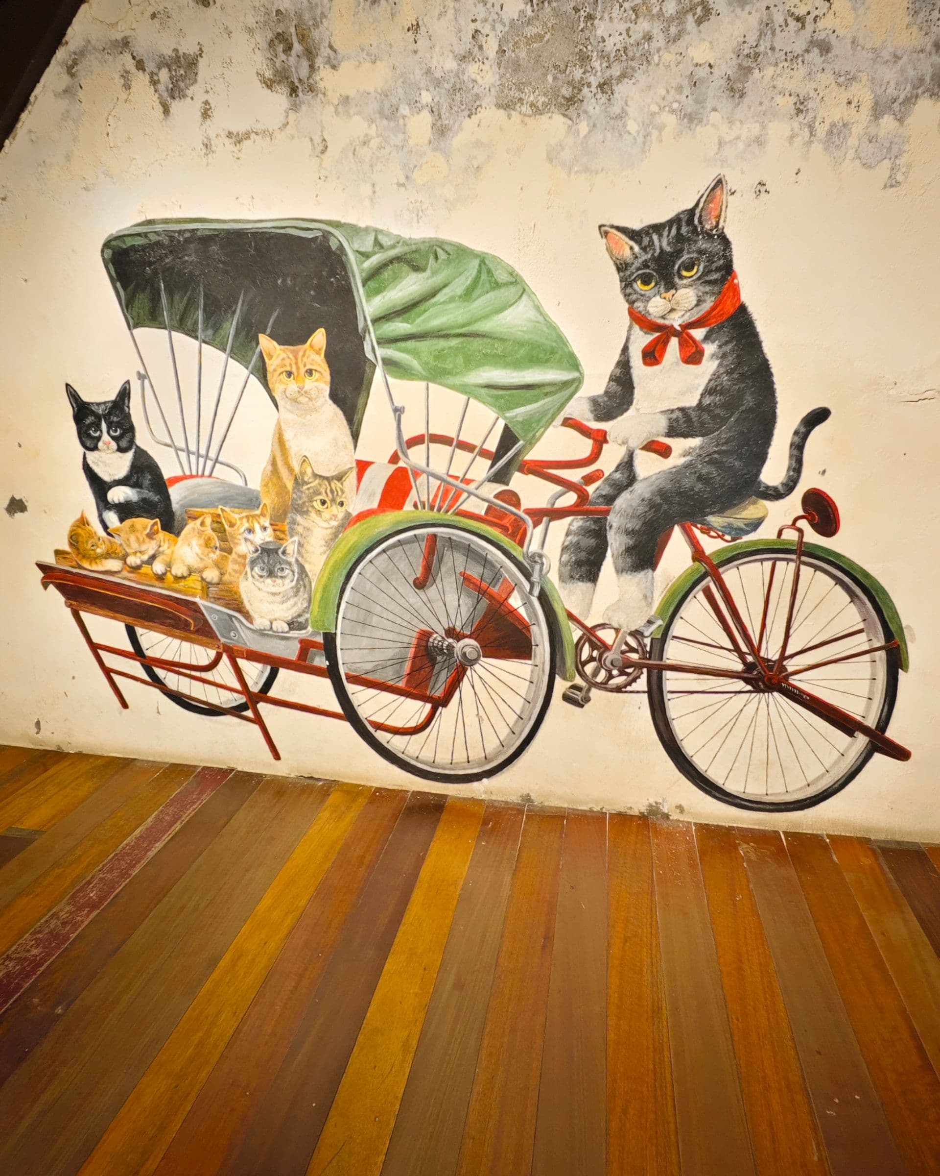 Cat decorations and painted cat artwork inside The Heritage Cat shop in George Town