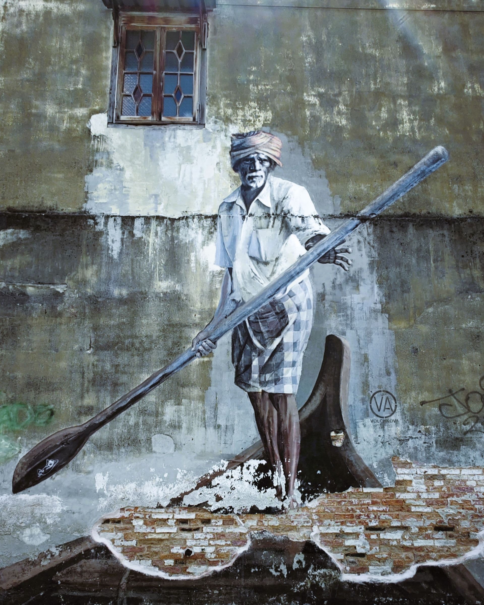 The Indian Boatman mural by Julia Volchkova in the alley off Stewart Lane, a photorealistic painted boatman