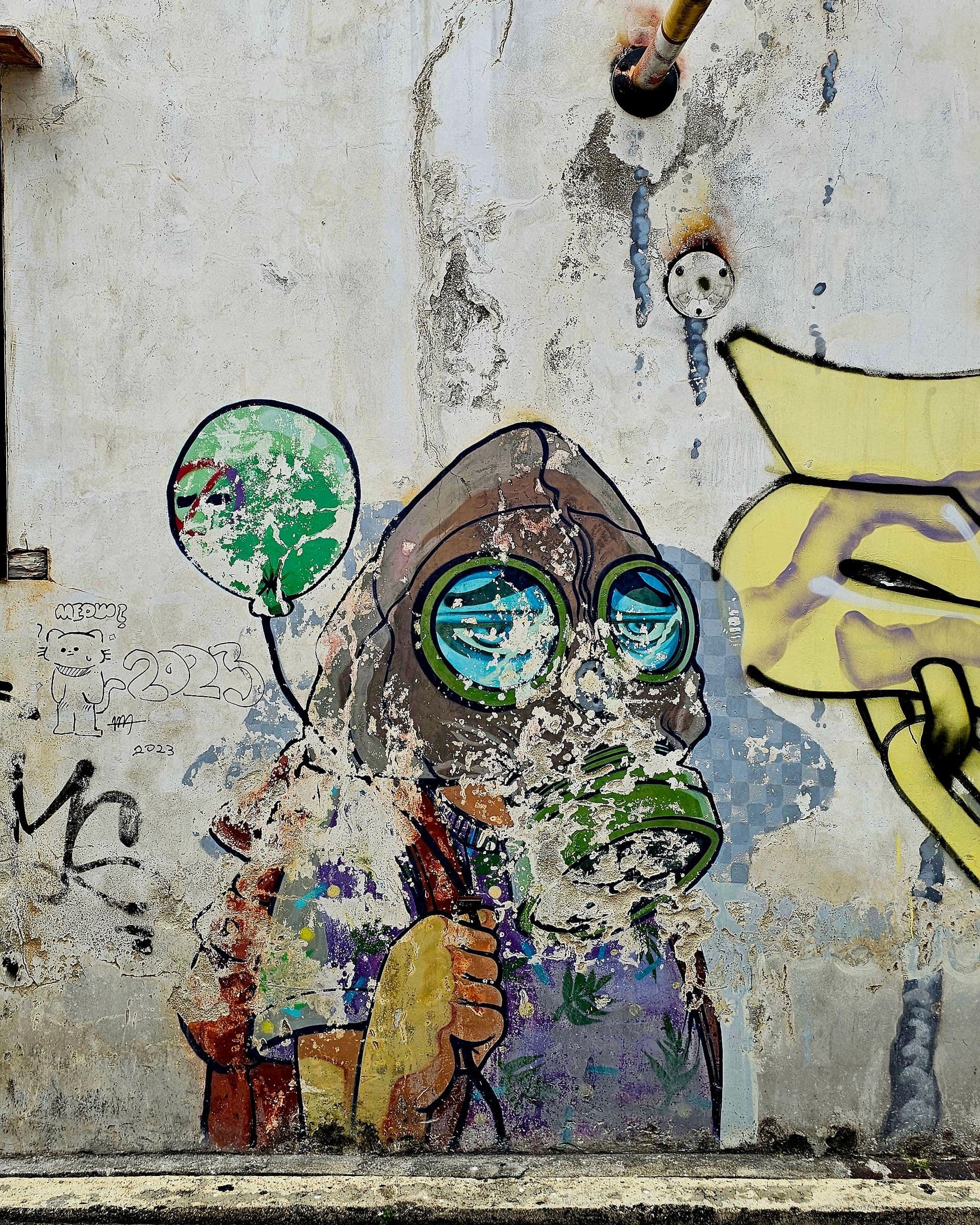Only You Can Stop Air Pollution mural by Cloakwork on Lebuh Ah Quee, a figure in a gas mask holding a green balloon